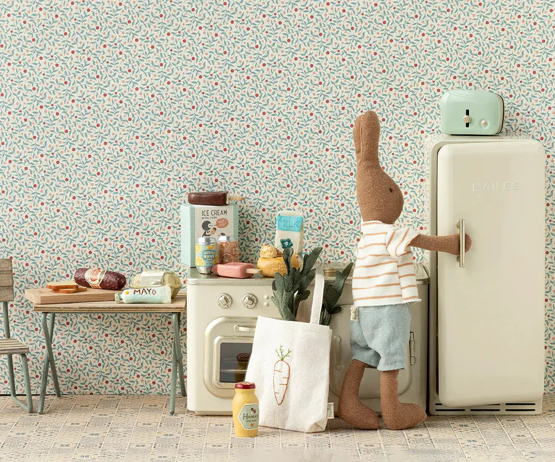 Maileg canapé miniature dollhouse kitchen scene; cream fridge, stove, rabbit figure in striped shirt, tote bag.