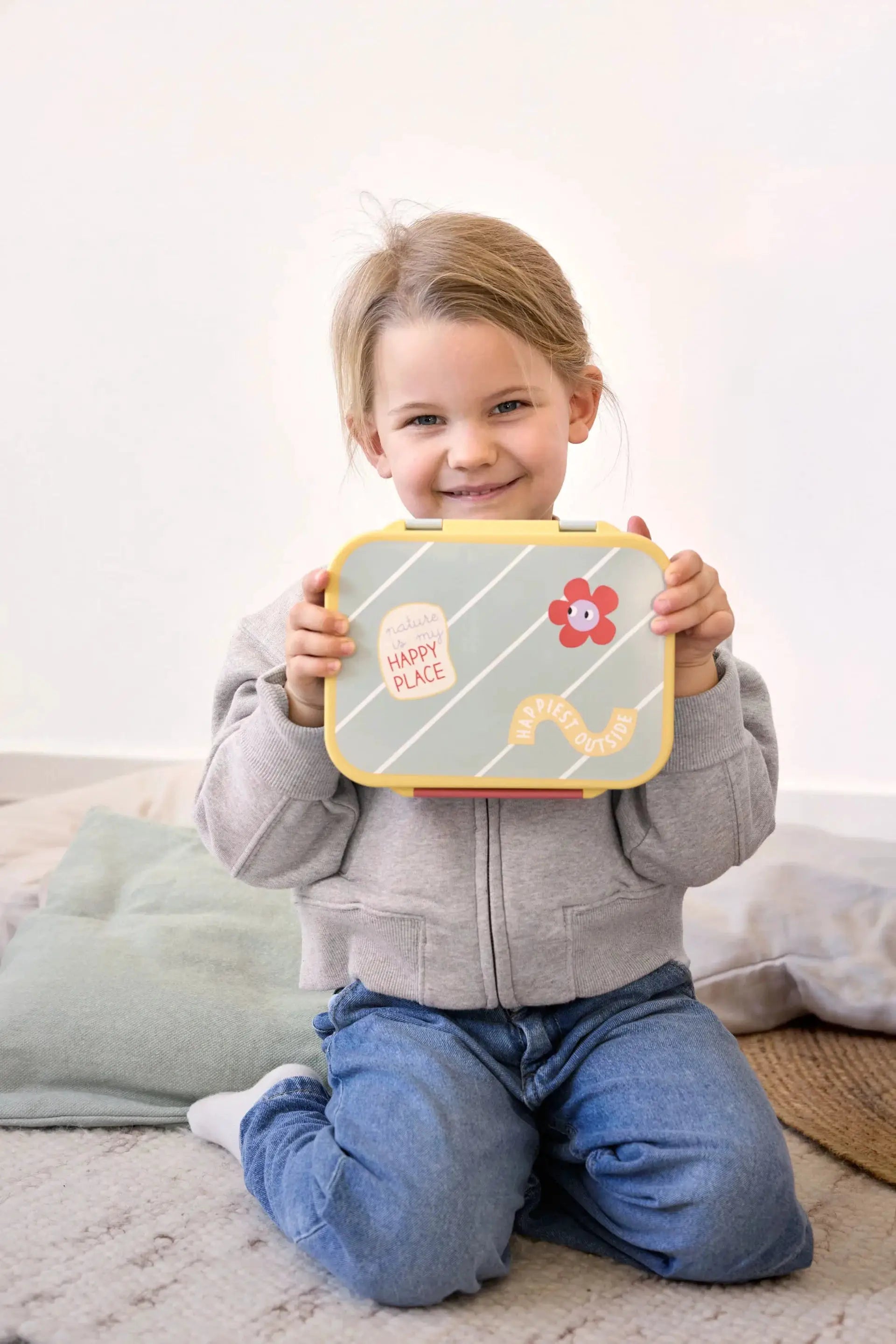 LÄSSIG bento lunchbox Happy Trails/Flower; yellow rim, pastel blue striped lid with a flower sticker