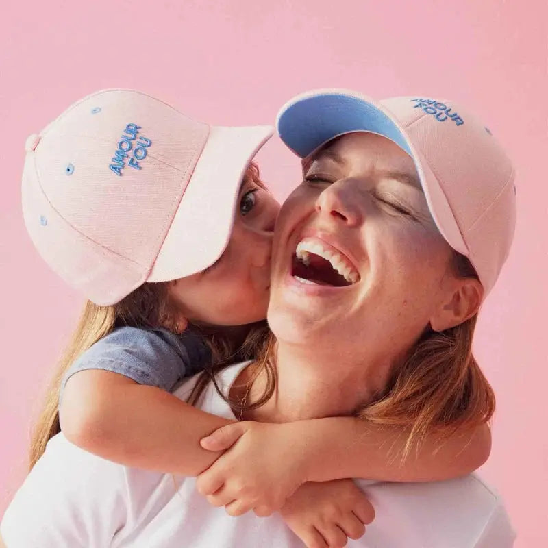 CHAMAYE casquette amour fou baseball caps, pink with blue AMOUR FOU embroidery, worn by two people