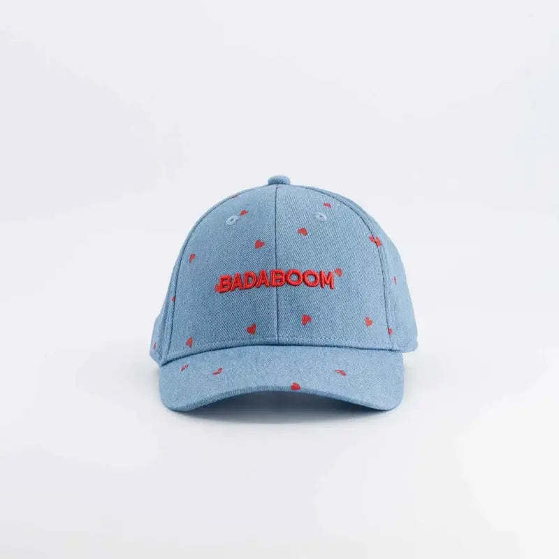 CHAMAYE denim baseball cap with red BADABOOM embroidery and small red heart accents on light blue denim
