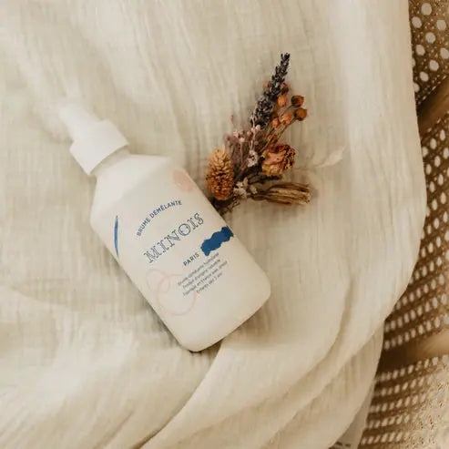 MINOIS detangling spray in a white pump bottle with blue label by Citron Grenadine