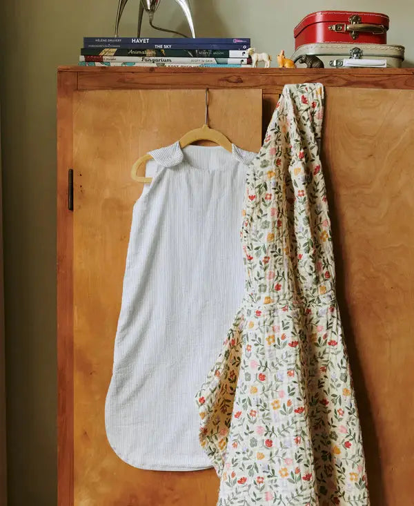 Dear April Sylvia gigoteuse TOG1 dew stripe, pale blue striped baby sleepsack on a hanger.