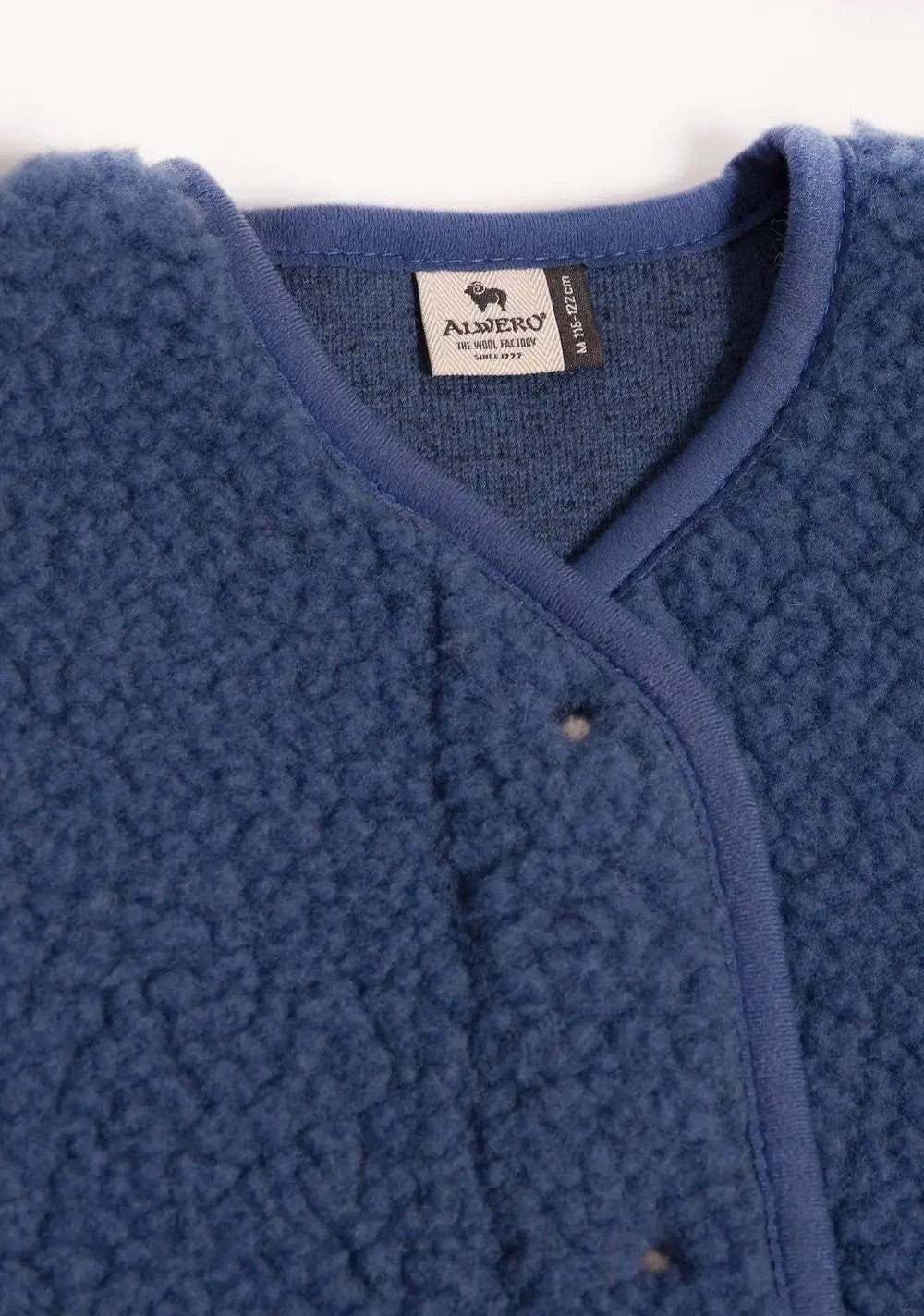 ALWERO wool gilet in blue with fleece texture, close-up of collar and tag