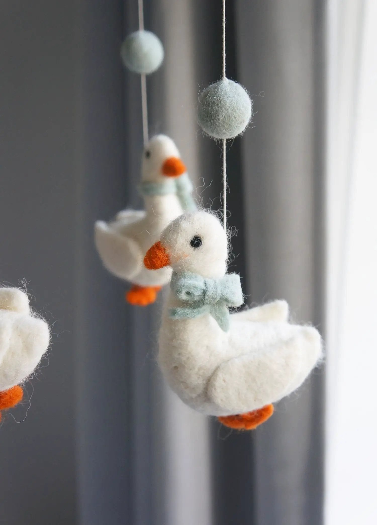 GAMCHA mobile goose felt crib decor by Citron Grenadine; white birds with light blue accents and orange beaks