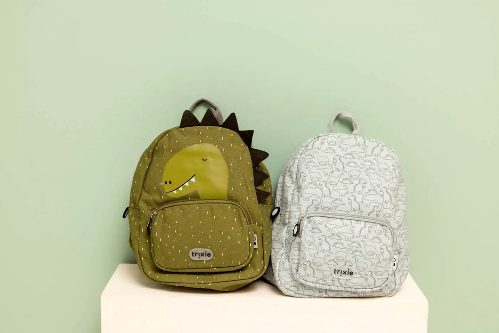 Two TRIXIE sac-à-dos backpacks: olive-green daring dino with spikes and gray dinosaur-print backpack