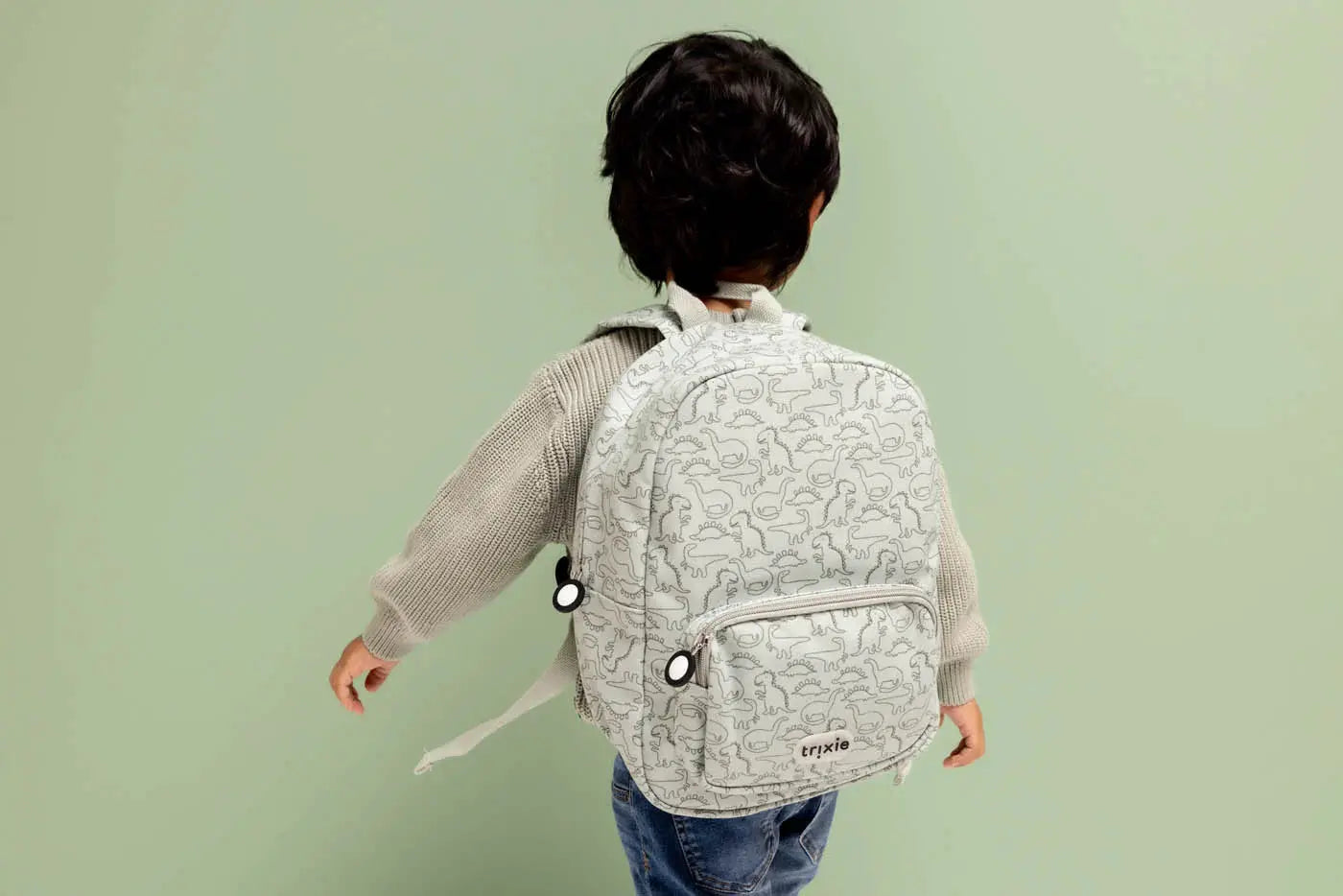 TRIXIE sac à dos scolaire gris clair à motif dinosaures, logo TRIXIE.