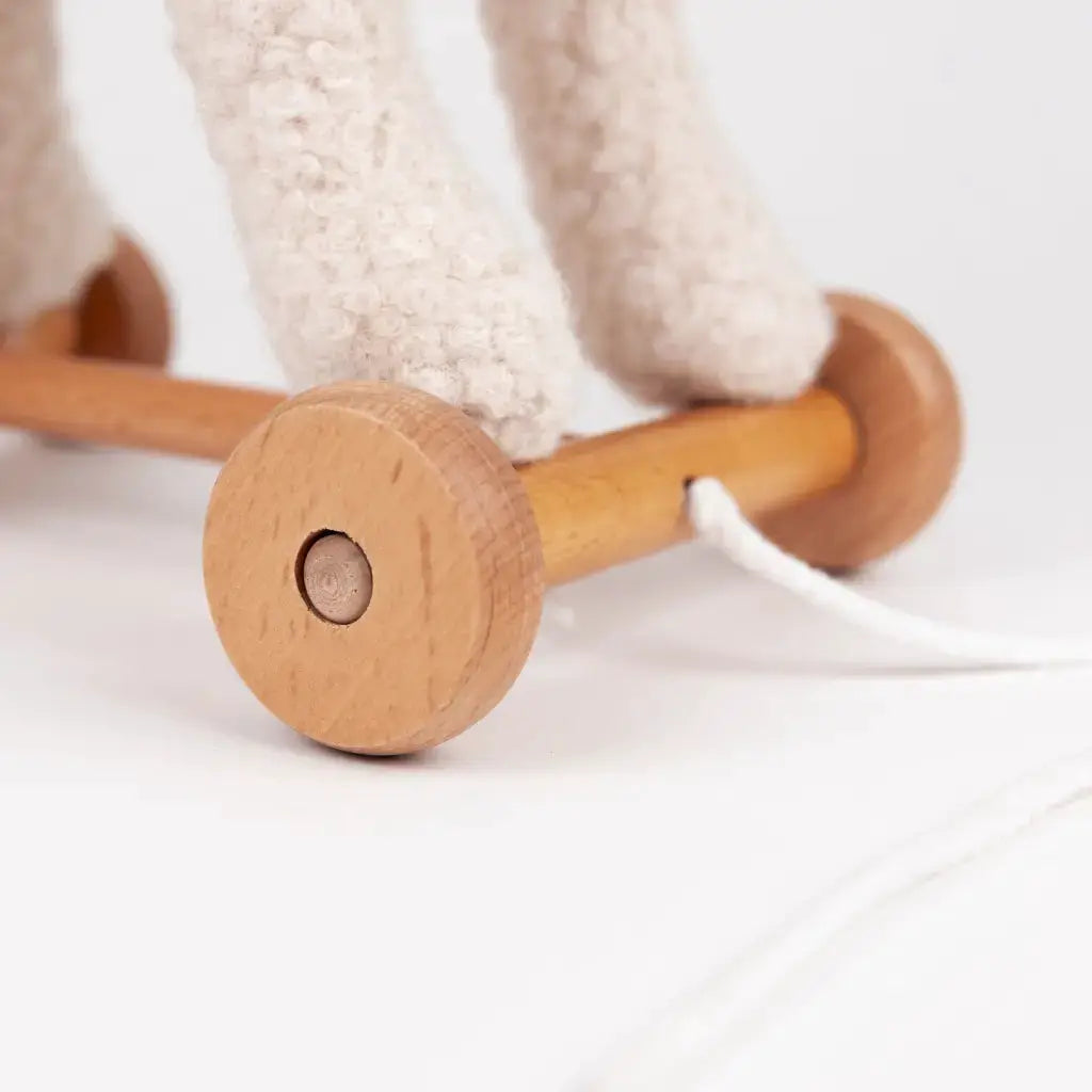 Pull-along toy Mary by Citron Grenadine, wooden wheels and knitted fabric legs