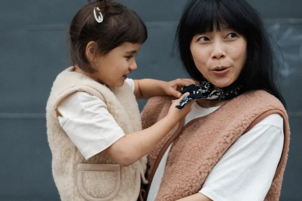 ALWERO bodywarmer TYB rugby tan; two fluffy fleece vests worn by woman and child