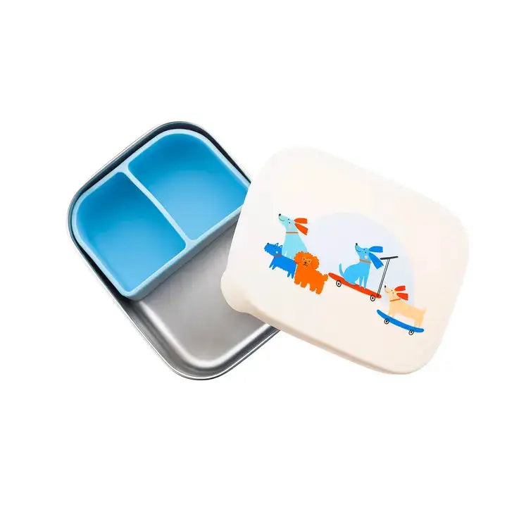 The Cotton Cloud lunchbox, two-compartment metal tin with blue interior and a white lid with dog illustrations