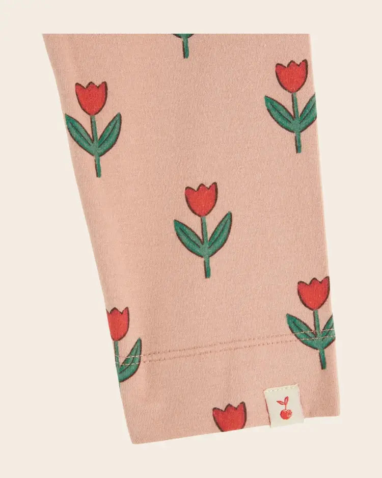 Emile et Ida legging by Citron Grenadine in soft pink with repeating red tulip motifs and green stems, soliflore print