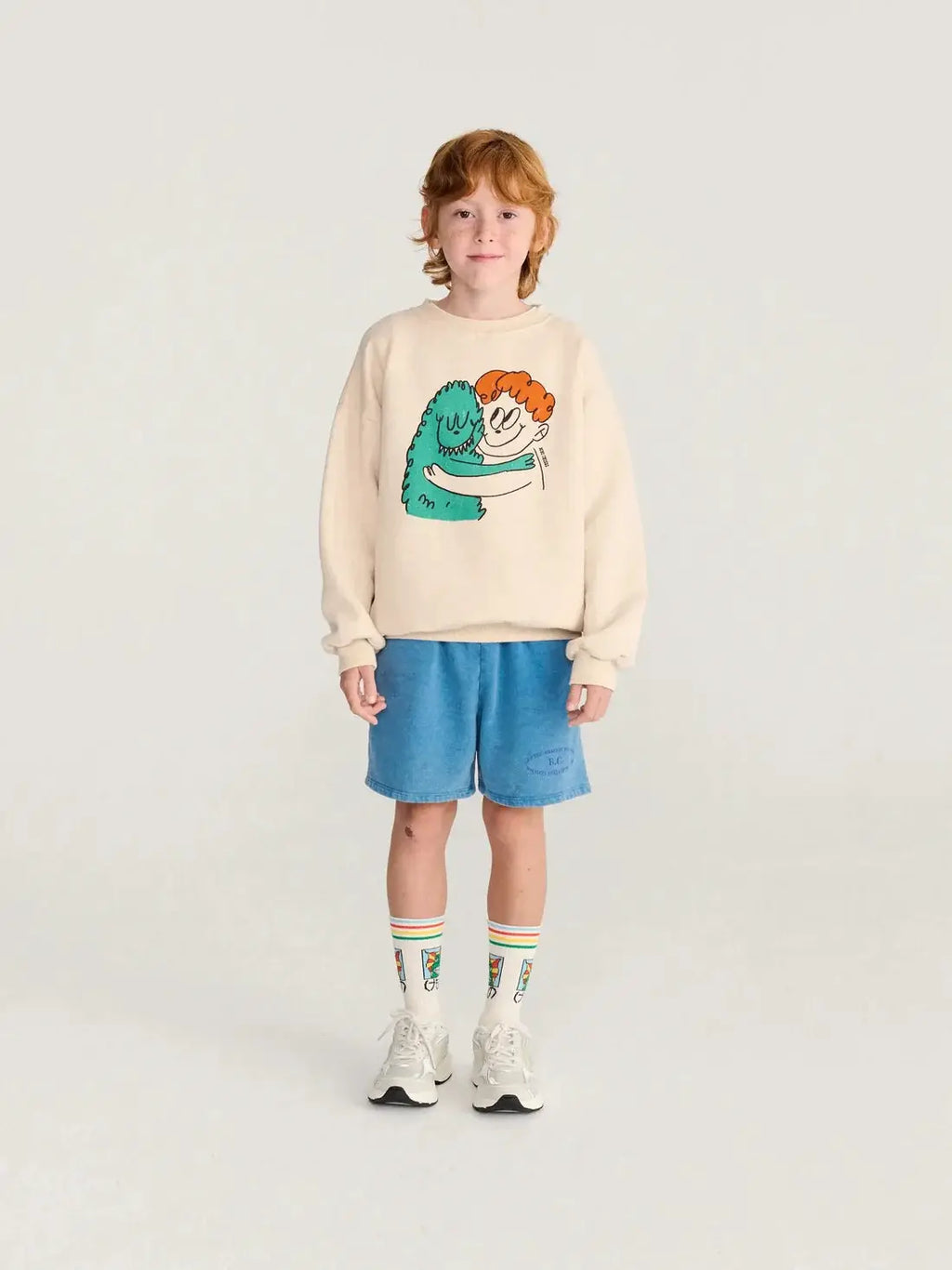 BOBO CHOSES hug hairy monster sweatshirt, beige with teal monster hugging an orange-haired child