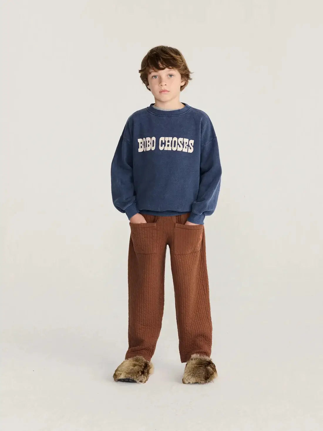 BOBO CHOSES Pop sweatshirt, blue with white logo, worn by a child