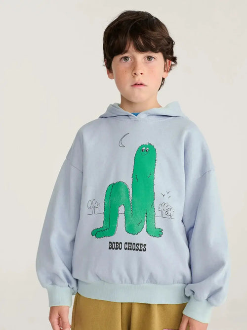 BOBO CHOSES long puff hoodie sweatshirt for kids, light blue with large green cartoon graphic on front.