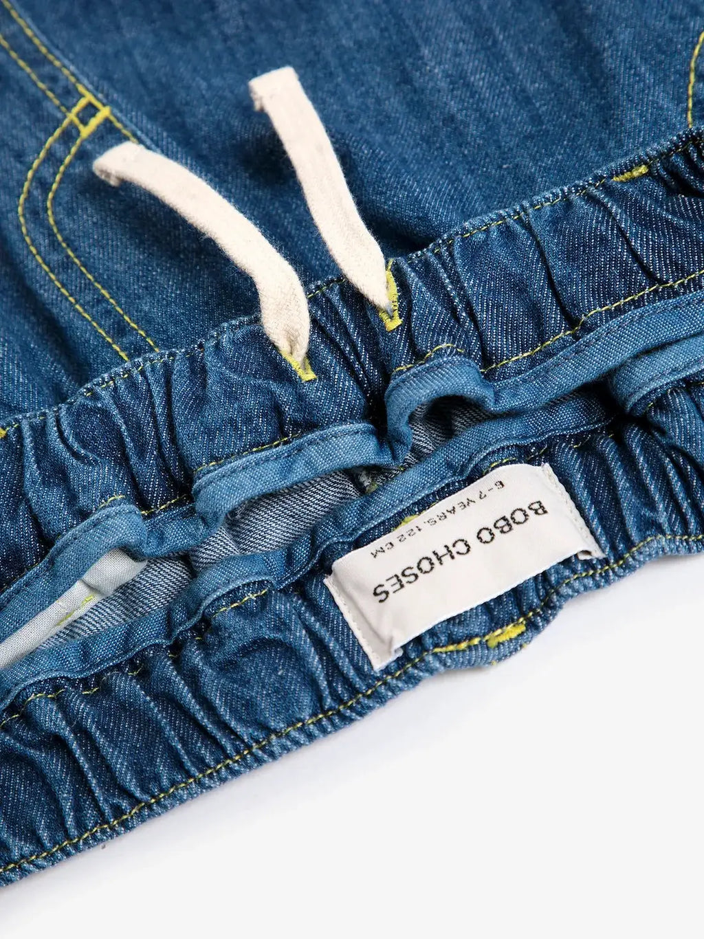 BOBO CHOSES denim jeans with elastic waist and white drawstrings; yellow stitching and brand label visible