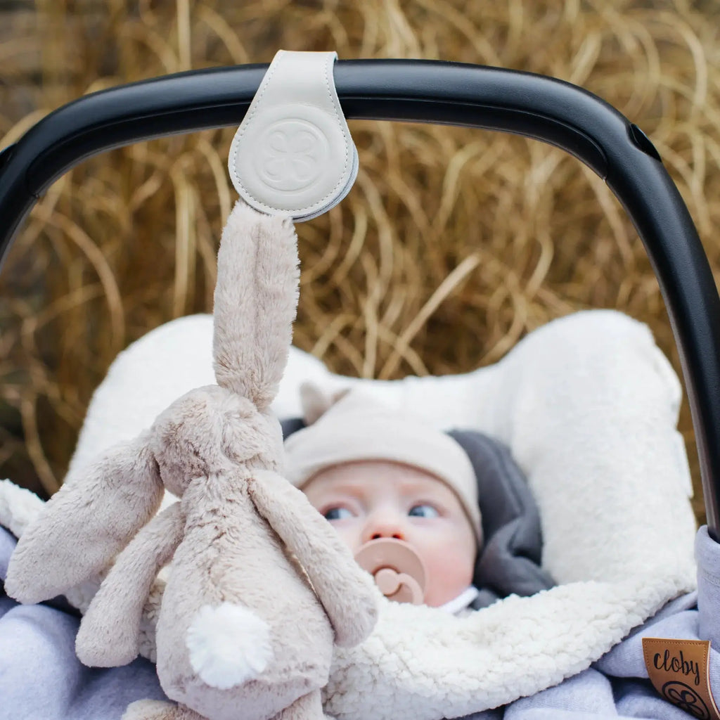 CLOBY clips beige stroller hook on handlebar; Cloby logo patch visible.