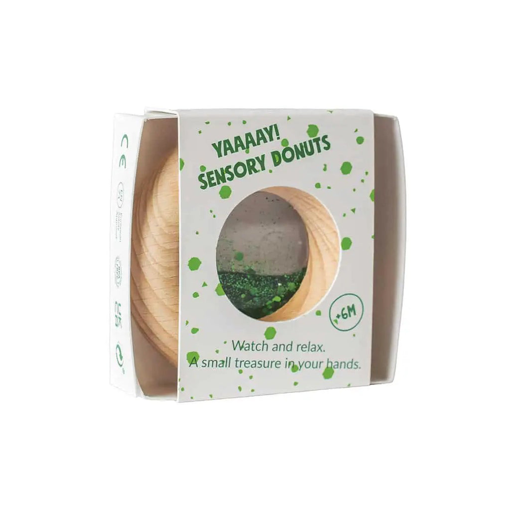 Petit Boum donut sensoriel green teething toy by Citron Grenadine, wooden donut design in box