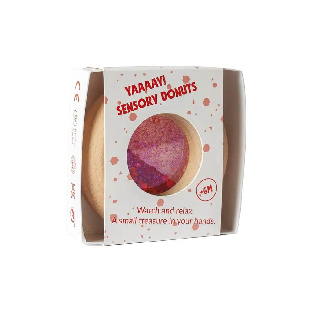 Petit Boum sensory donut teether red with glitter, packaged in a white box