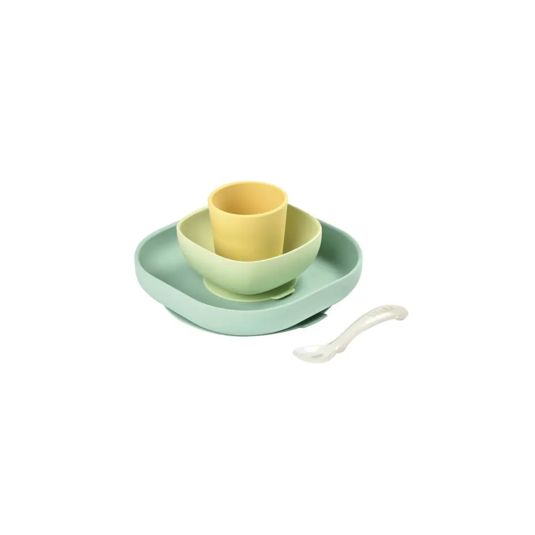 BÉABA four-piece silicone meal set in yellow and mint green with a spoon
