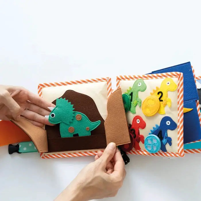 JOLLY DESIGNS livre d'éveil en tissu dinosaures colorés avec chiffres 1–4, pages à volets orange rayé