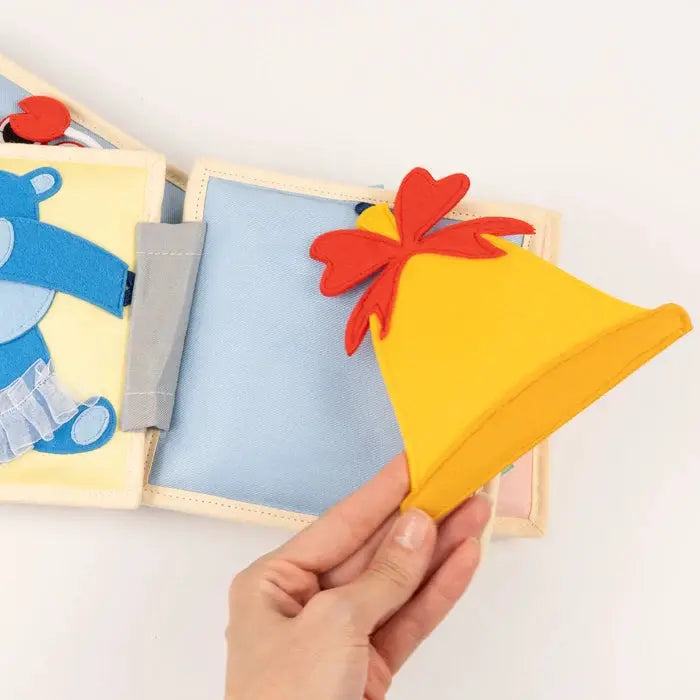 JOLLY DESIGNS livre d'éveil pour bébés 4m+ pages en tissu et cloche jaune en feutrine