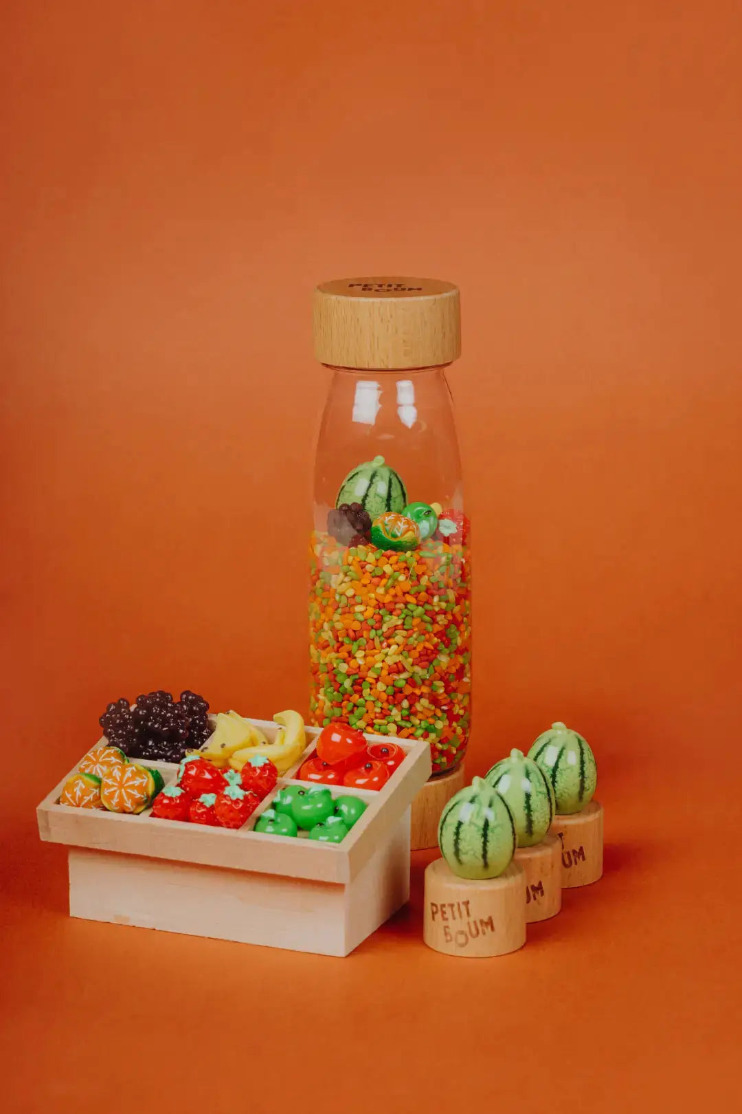 PETIT BOUM learn bottle fruits; glass bottle with wooden cap, colorful beads and fruit toys by Citron Grenadine