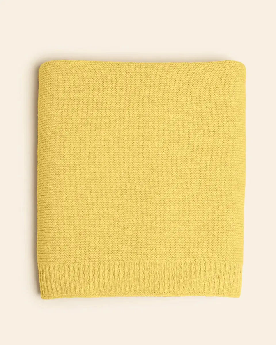 Katarina buttercup knit throw blanket, folded with ribbed edge