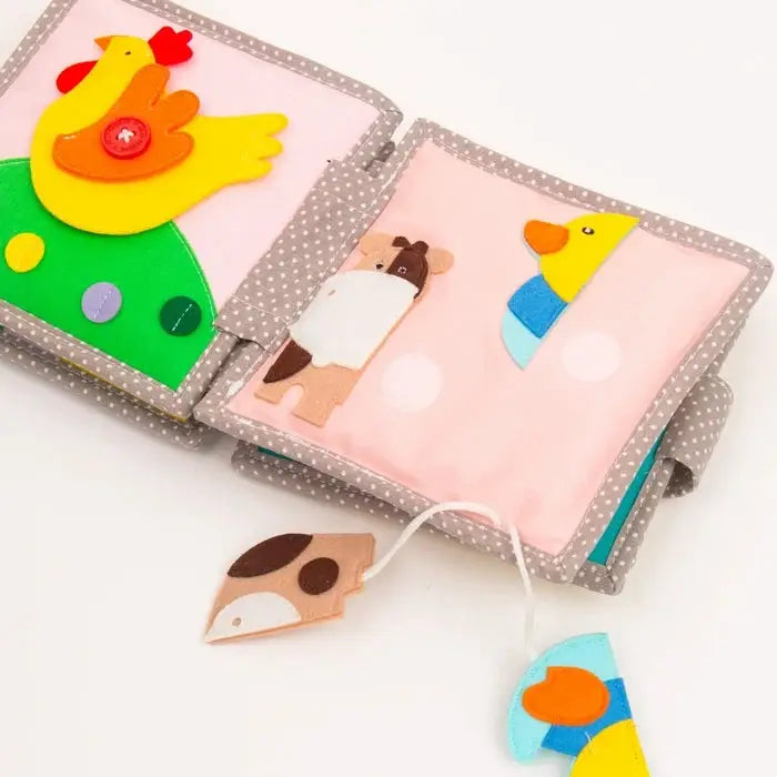 JOLLY DESIGNS livre d'éveil en tissu Citron Grenadine; pages roses avec animaux colorés sur fond gris à pois