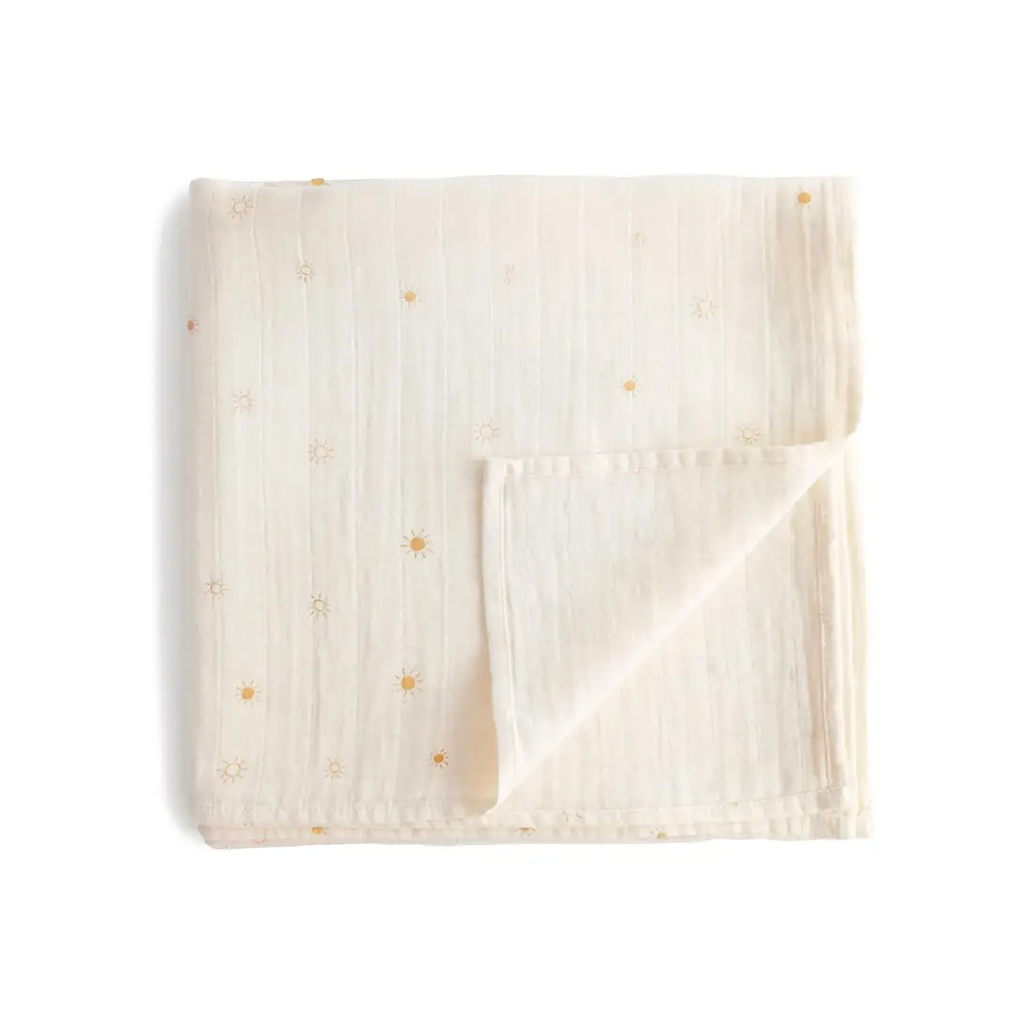 MUSHIE muslin swaddle blanket with tiny yellow sun motifs on cream