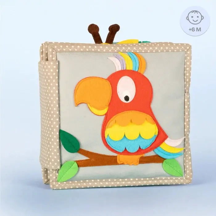 JOLLY DESIGNS livre d’éveil en tissu; perroquet coloré rouge/orange avec ailes arc-en-ciel sur cadre beige à pois
