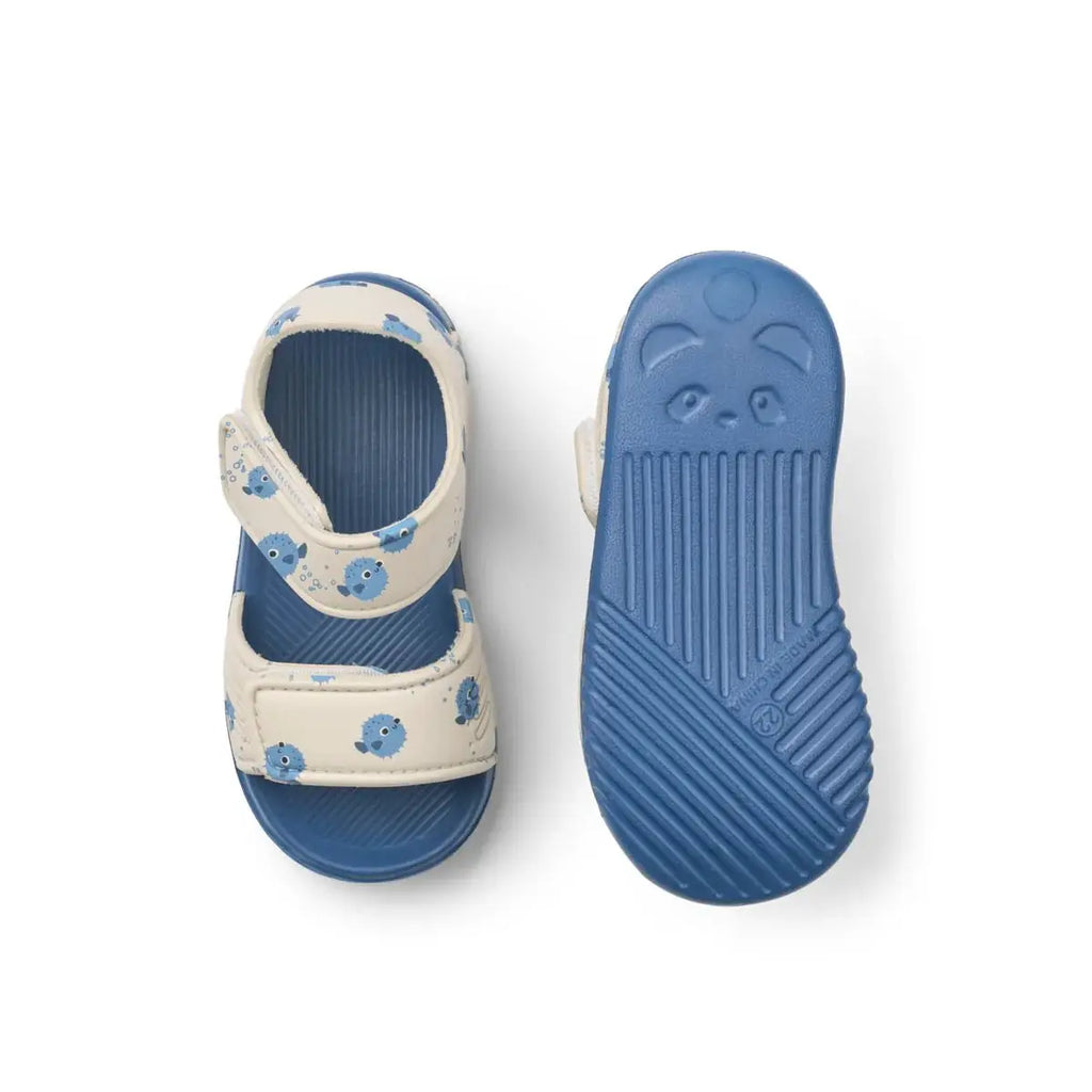 Baby sandals by Citron Grenadine with beige straps and blue pufferfish pattern, blue sole.