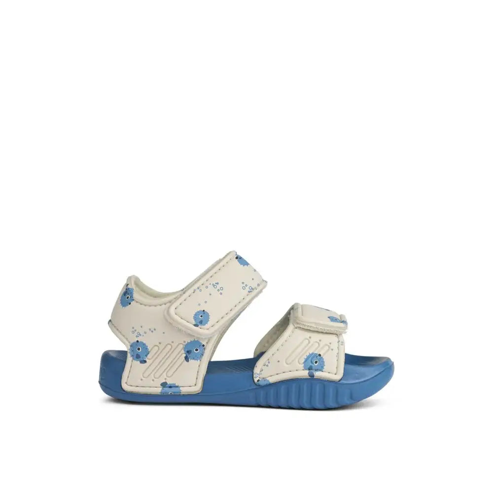 LIEWOOD baby sandals with white straps featuring blue pufferfish print on a blue sole with Velcro closures
