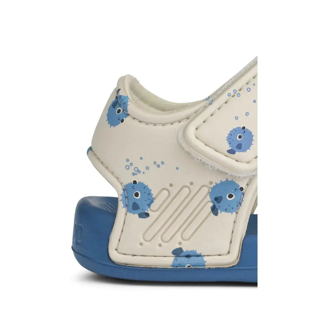 Blumer baby sandal by LIEWOOD with blue pufferfish print on white upper and blue sole