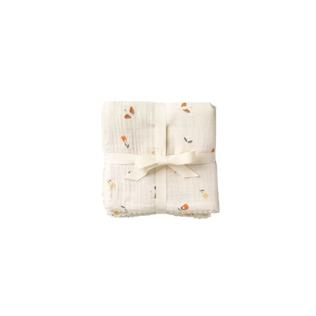 Swaddling blankets set of 3 with songbirds print on white muslin, tied with cream ribbon.