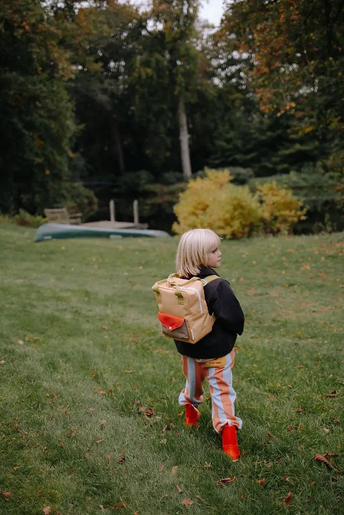 Sticky Lemon school backpack in tan with orange front pocket and green straps