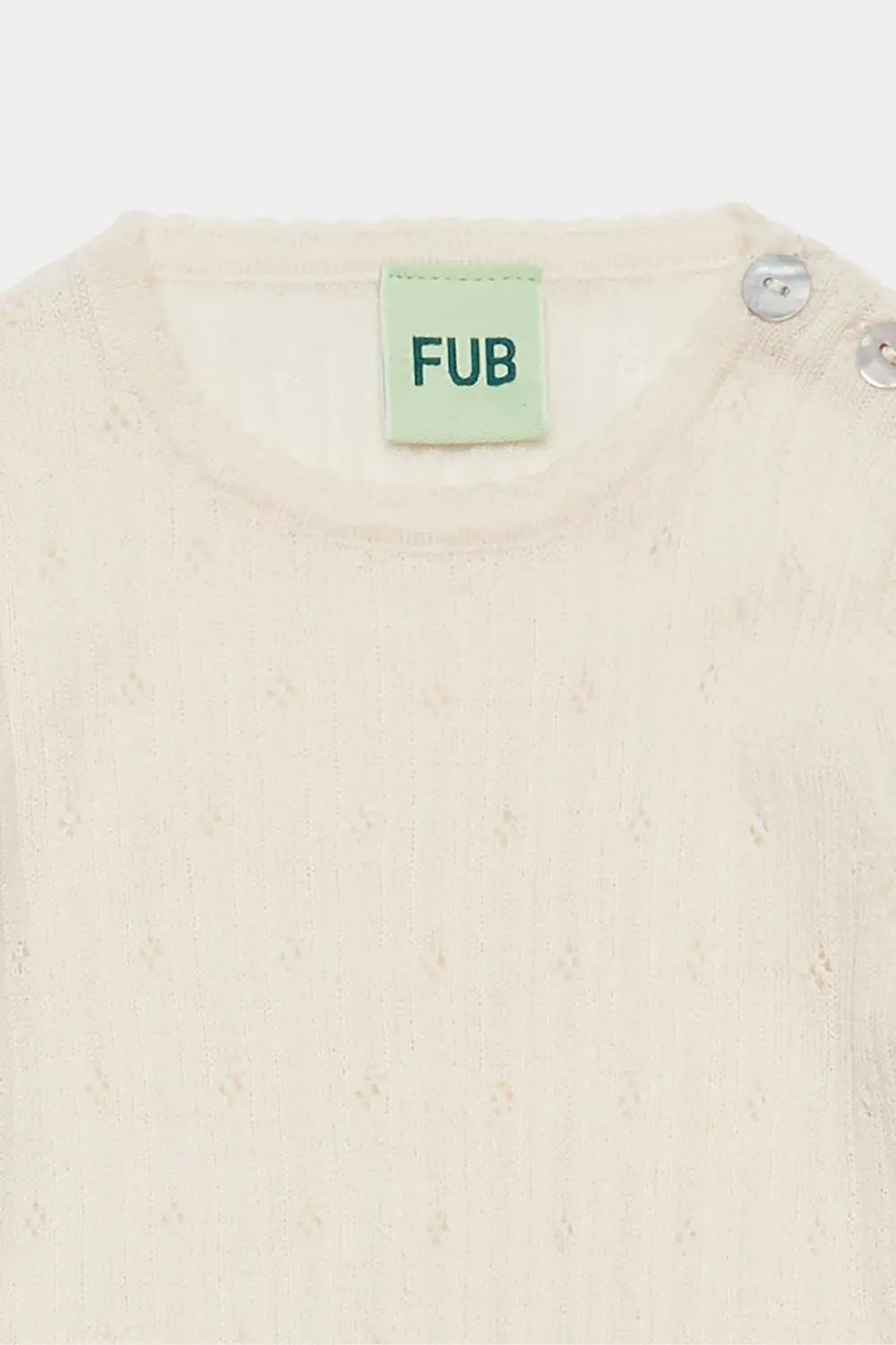 FUB body en merinos écru à pointelle, boutons sur l'épaule; label FUB visible