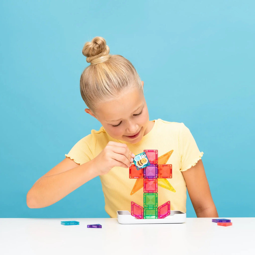 CONNETIX Travel Mini Pack 32 pc magnetic tiles; child builds colorful translucent blocks on a white table