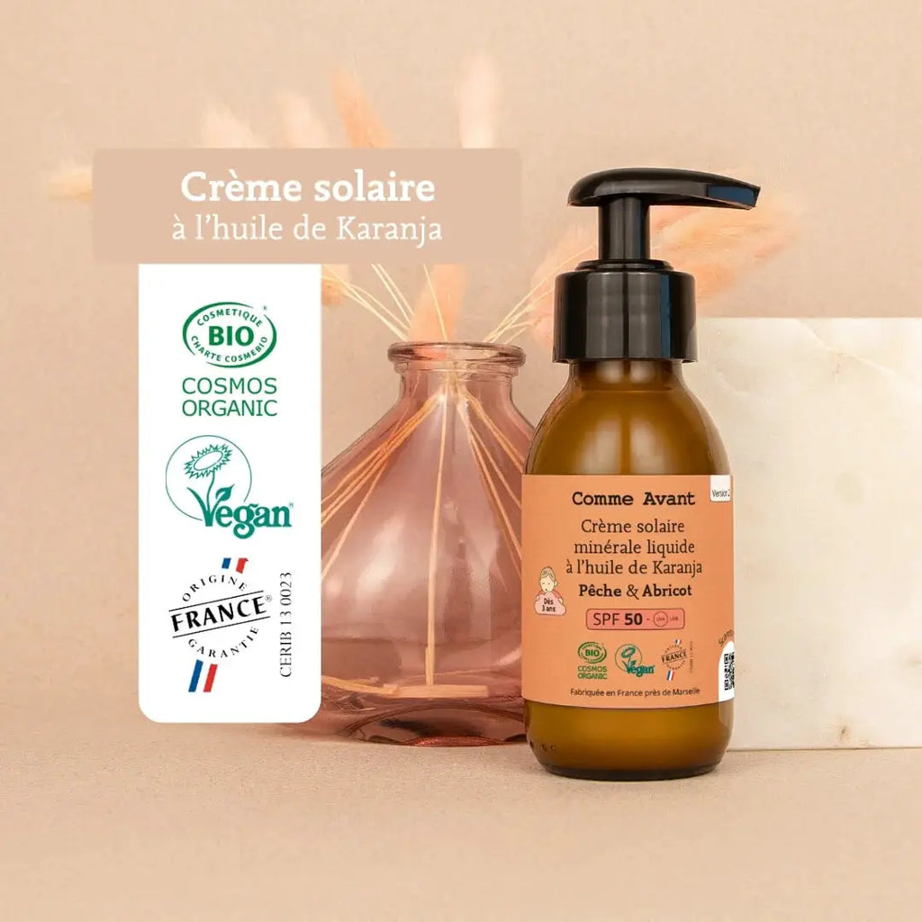 COMME AVANT crème solaire minérale liquide SPF50 à l'huile de karanja et vanille, bouteille ambrée de Citron Grenadine