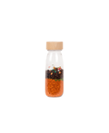 PETIT BOUM sensory bottle rabbit by Citron Grenadine; wooden cap, clear bottle with orange beads and rabbit motifs.