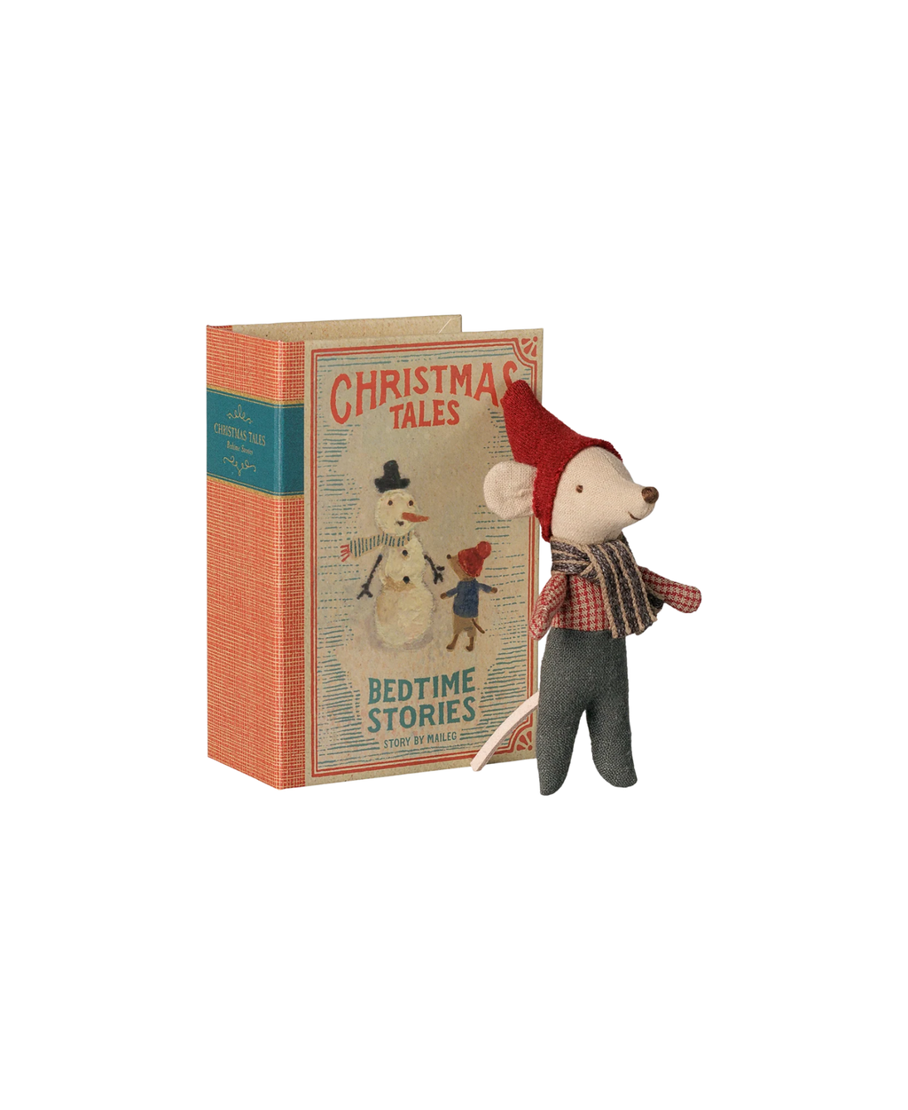 Maileg bébé souris de Noël dans un livre, souris en tissu avec chapeau rouge près d’un livre illustré Noël