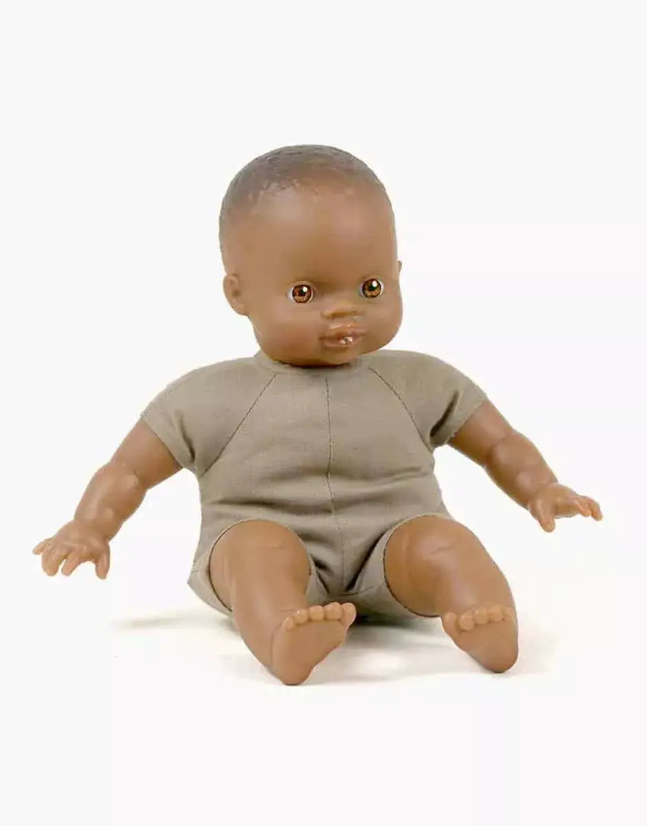 MINIKANE Ondine 28 cm doll, brown-skinned baby in beige romper, seated