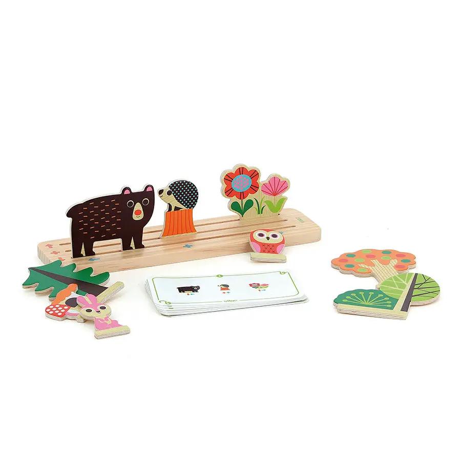 Wooden forest-themed board game pieces with bear, hedgehog, owl, flowers, trees and a deck of cards.