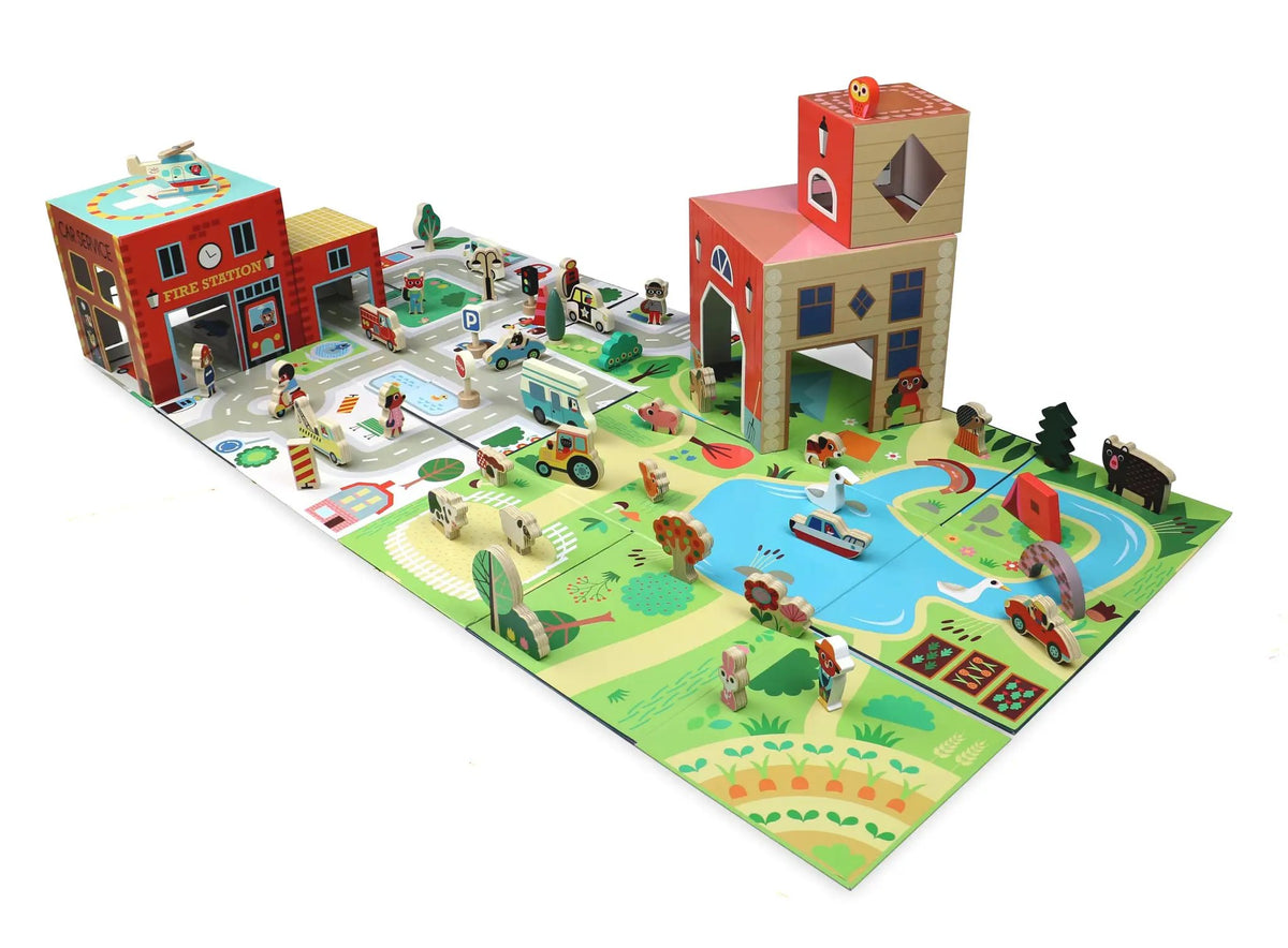 VILAC cube pop up outdoor playset by Citron Grenadine; colorful cityscape with red fire station, roads and towers.