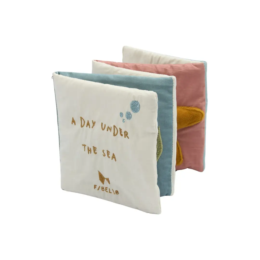 FABELAB fabric book set for babies; three soft cloth activity books in cream, blue, and pink with sea motif